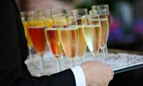 Tray of colorful glasses filled with Champagne